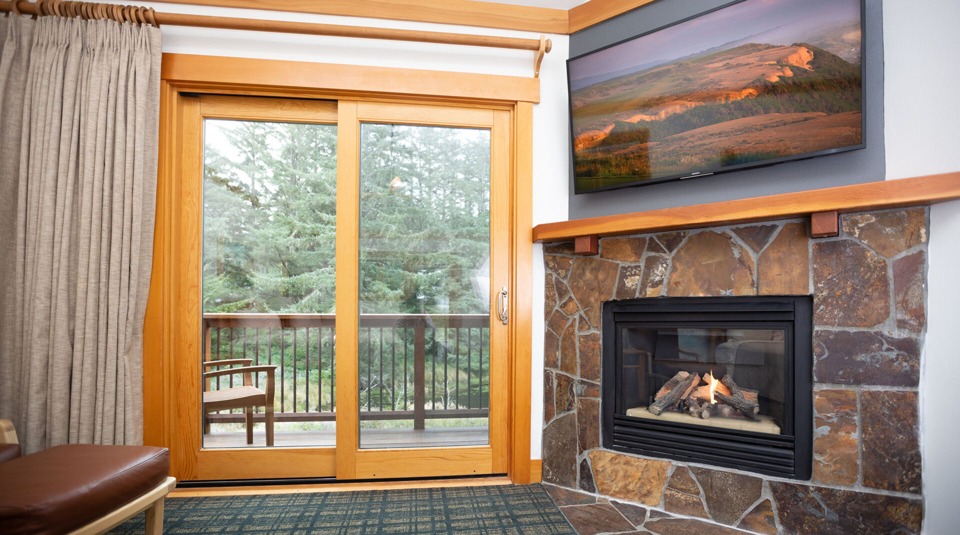 A doorway to a balcony at Lily Pond next to a fireplace
