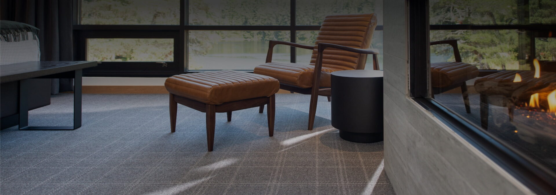 Round Lake interior room showing a chair, ottoman, and fireplace